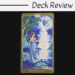 A tarot card from The Book of Shadows Tarot Volume 2 titled The High Priestess shows a woman in a blue dress by a moonlit lake, meeting a ghostly figure, with trees and a large, face-like moon above. Deck Review text appears at the top.