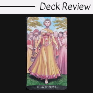 A tarot card from the Gregory Scott Tarot, titled The Empress, shows a regal woman in a golden gown and crown, standing confidently outdoors among people in medieval attire, with trees and blue sky in the background.