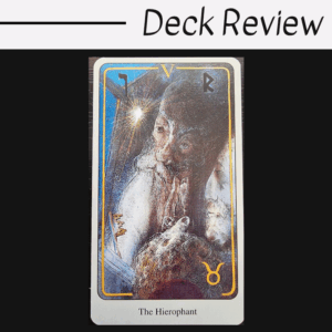 A tarot card titled The Hierophant from the Haindl Tarot shows a mystical figure with a long beard, surrounded by light and symbols, set against a blue and gold background. Deck Review is written above the card.