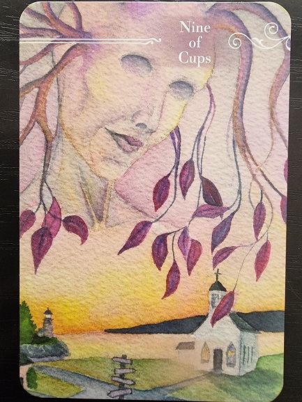 A Guardian Tarot card, Nine of Cups, features a serene, ethereal face emerging from swirling branches with pink leaves above a small white church at sunset, with a winding path and distant trees in the background.