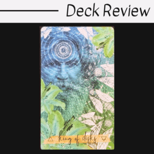 A tarot card from the Journey of the Sacred Bee Tarot labeled king of disks features a blue-tinted, bearded man's face with swirling patterns and leafy green plants, set against a black and white Deck Review header.