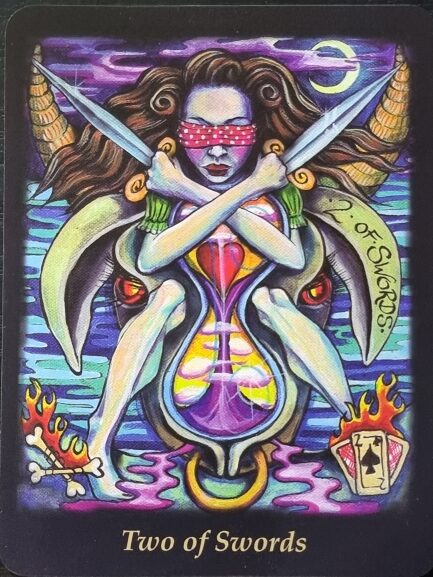 A vibrant Bonefire Tarot card illustration of the Two of Swords shows a blindfolded woman with crossed arms holding swords. She sits on a surreal creature, surrounded by water, flames, and a crescent moon in the background.