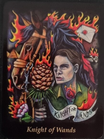 A Bonefire Tarot card titled Knight of Wands depicts a determined person next to a horse, surrounded by flames. The card features a pinecone, a heart, flowers, and an envelope with a red seal, all framed by fiery colors.