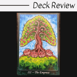 A tarot card titled III ~ The Empress from the Tarot of Trees deck shows a flourishing tree with red fruit and swirling branches, rooted on green hills under a bright blue sky. Deck Review is written above in black text on a white background.