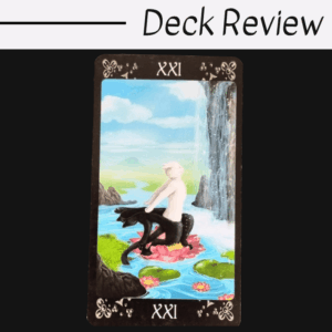 A tarot card from the Black Cats Tarot labeled XXI shows a pale figure riding a black sea creature in a vibrant water landscape with lilies, rocks, green hills, and a waterfall. The words Deck Review appear at the top.