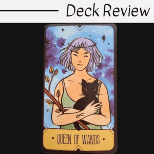 A tarot card from The Sasuraibito Tarot titled Queen of Wands shows a woman with short purple hair holding a black cat and a flowering wand, set against a blue and purple starry background. The words Deck Review appear above the card.