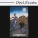 A tarot card from the Animal Totem Tarot, labeled Ten of Pentacles, features three rabbits in front of a burrow at dusk. Ten pentacles are embedded above the entrance, with a full moon overhead. “Deck Review” is written at the top.