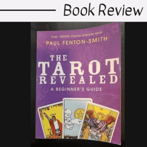 A purple book titled The Tarot Revealed: A Beginners Guide by Paul Fenton-Smith is pictured, featuring three tarot cards—The Magician, The Moon, and The Sun—on the cover. “Book Review” appears above this guide to tarot wisdom.