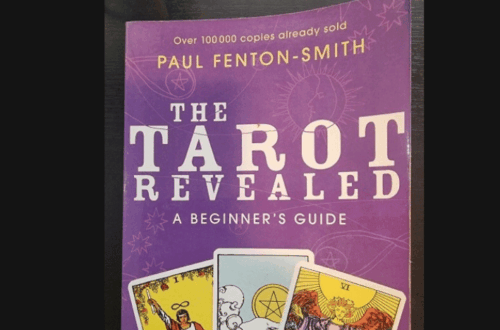 A purple book titled The Tarot Revealed: A Beginners Guide by Paul Fenton-Smith is pictured, featuring three tarot cards—The Magician, The Moon, and The Sun—on the cover. “Book Review” appears above this guide to tarot wisdom.