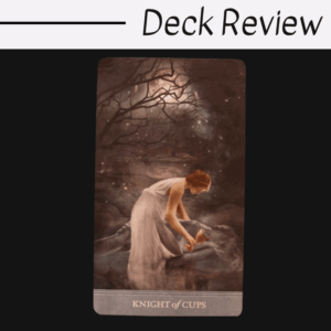 A tarot card from The Dreamkeepers Tarot, titled Knight of Cups, shows a woman in a white dress kneeling by water under a moonlit, starry sky with branches framing the scene. Deck Review is written at the top.