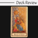 A tarot card labeled Queen of Coins from The Medieval Scapini Tarot features a richly dressed woman sitting and holding a coin aloft, with ornate patterns in the background. The words Deck Review appear above the card.