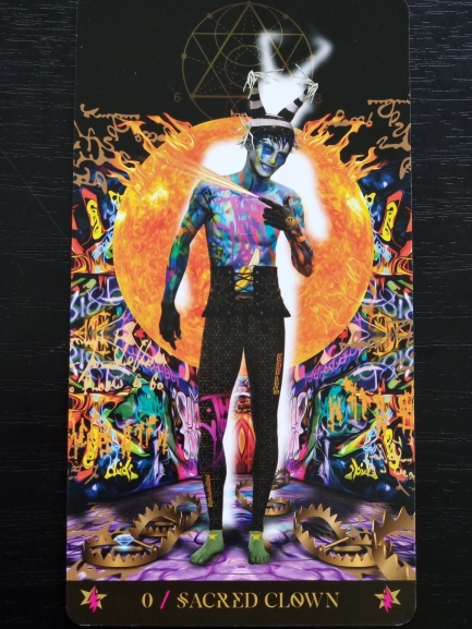 A poster of a man with a painted face inspired by the Starman Tarot.