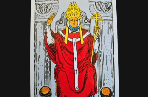 Illustration of The Hierophant tarot card showing the hierophant in red robes seated between two pillars, holding a staff, with two followers kneeling before him. The card name appears at the top.