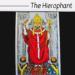 Illustration of The Hierophant tarot card showing the hierophant in red robes seated between two pillars, holding a staff, with two followers kneeling before him. The card name appears at the top.