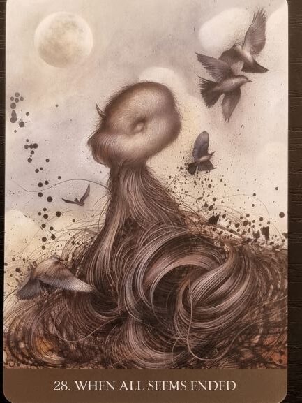 Surreal artwork of a headless figure with long, flowing hair blending into the ground, surrounded by flying birds, under two large moons. Into the Lonely Woods appears as text with “28. WHEN ALL SEEMS ENDED” at the bottom.