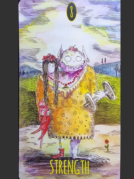 A whimsical card from The Shadowland Tarot labeled Strength shows a monster in a yellow dress holding a doll and dumbbell, with a smaller figure beside it. The background features hills, a cloudy sky, and a single red flower.