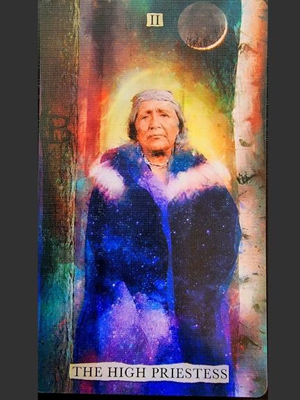 A Superlunaris Tarot card titled The High Priestess shows an elderly woman in a fur-trimmed coat, glowing with an ethereal aura, set against a cosmic, colorful background with trees and a crescent moon above her.
