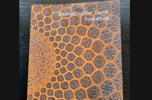 Journaling the Tarot: Evolutions by Andy Matzner features a geometric, mosaic-style patterned cover in brown and blue tones. Above the book is the text “Book Review” on a white background.