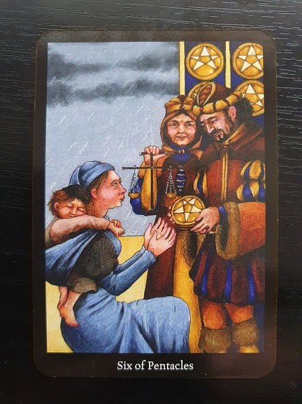 A tarot card titled Six of Pentacles shows a wealthy man giving coins to a kneeling woman holding a child, while another woman stands behind him holding scales. The scene suggests charity, generosity, and the importance of writing new stories of kindness.