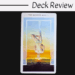 A tarot card titled The Hanged Man from the Fountain Tarot shows a glowing figure suspended upside down over a bright horizon, with the words Deck Review above the image on a white background.