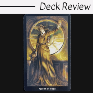 A tarot card labeled Queen of Cups from The Steampunk Tarot features a regal woman in a brown dress, holding a cup high. Behind her, golden light streams through a large, round window. Deck Review is written above the card.