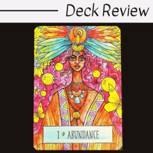 A colorful tarot card from The Earthcraft Oracle labeled 1 Abundance shows a woman with brown skin, flowing hair, and a vibrant feathered headdress. Surrounded by butterflies and yellow spirals, she radiates joy and prosperity.