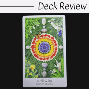 A tarot card from The Herbcrafter's Tarot, titled 21. The World - Pachamama, displays a mandala of colorful flower petals, leaves, stones, and a butterfly at its center on a grassy background. Deck Review is written above the card.