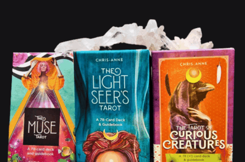 Three tarot card decks in colorful boxes—The Muse Tarot, The Light Seers Tarot, and The Tarot of Curious Creatures—are displayed side by side with a white crystal above them. Text reads “Blending Decks,” perfect for exploring blended decks.