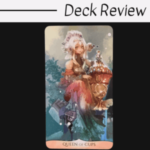 A tarot card titled Queen of Cups from the Traditional Manga Tarot deck features an anime-style woman with white hair, elaborate clothing, and a large ornate cup, set against a nature background. Above the card, text reads Deck Review.
