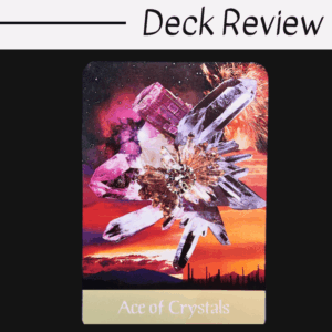 A tarot card titled Ace of Crystals from the Voyager Tarot shows a cluster of sparkling crystals against a vibrant, colorful sunset sky with fireworks and desert silhouettes. The words Deck Review are at the top.