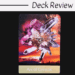 A tarot card titled Ace of Crystals from the Voyager Tarot shows a cluster of sparkling crystals against a vibrant, colorful sunset sky with fireworks and desert silhouettes. The words Deck Review are at the top.