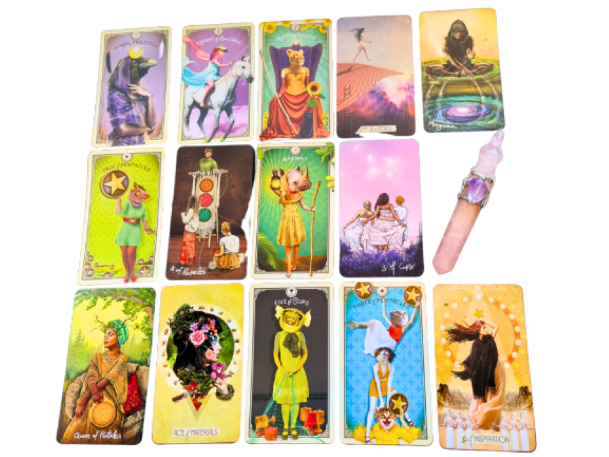 Fourteen colorful tarot cards from blended decks are arranged in a grid on a white surface, with a crystal-topped wand placed to the right of the cards in the second row. Each card features vibrant, whimsical illustrations.
