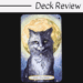 A tarot card from the Soul Cats Tarot titled XVIII - The Moon shows a black and white cat with yellow eyes, sitting before a glowing full moon, wearing a necklace with fish and leaf charms. The text Deck Review appears above.