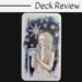 A tarot card titled XVII Star from The Unfolding Path Tarot features a woman with long white dreadlocks holding a chalice, set against a starry night sky. The words Deck Review appear above the card on a white background.