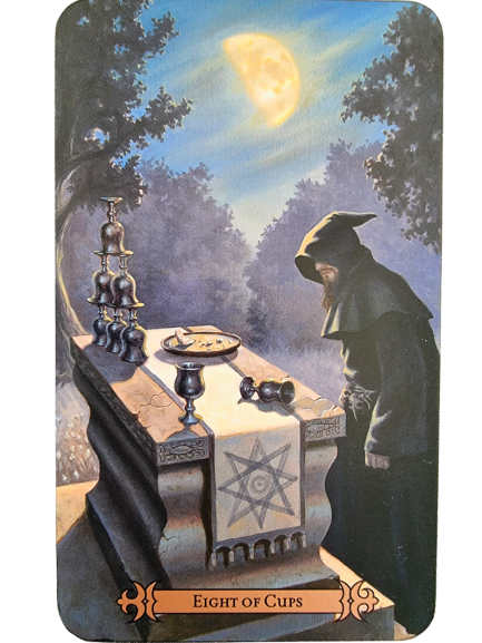 A hooded figure stands by a stone table engraved with a star, holding eight cups, under a crescent moon in a twilight forest. This mystical scene from the Modern Spellcaster's Tarot hints at departure or reflection. Text reads Eight of Cups.