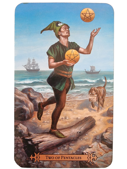 A man in green juggles two pentacles on a rocky beach, with ships sailing in the background. A dog runs beside him, carrying a letter in its mouth. The card is labeled Two of Pentacles from the Modern Spellcaster's Tarot.