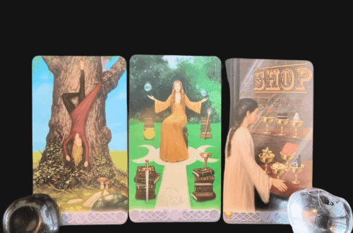 Three tarot cards are displayed side by side on a black background with “Tarot Spread” written above, inviting you to overcome a fear-based block. Two stones, one black and one clear, are placed at the corners of the cards.
