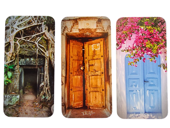 Three Divine Doors await: one entwined with tree roots, one of ornate, weathered wood, and a bright blue door set in a white wall crowned with pink flowers.