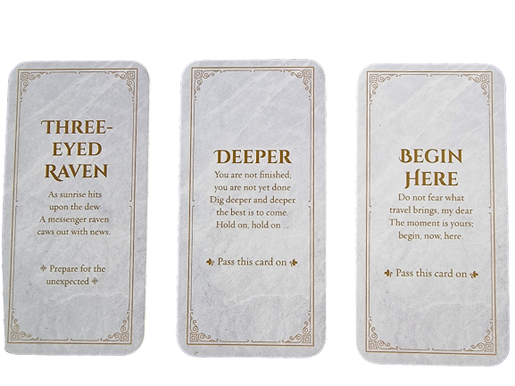 Three tarot-style cards with gold text, inspired by Divine Doors. The cards read: THREE-EYED RAVEN, DEEPER, and BEGIN HERE, each featuring an uplifting message and pass-it-on instructions. All are set against a marble-like background.