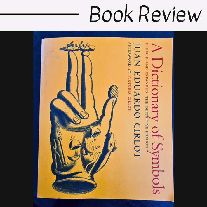 A book titled A Dictionary of Symbols by Juan Eduardo Cirlot with a yellow cover featuring an illustrated hand and small figures. Above the book is text that reads Book Review, highlighting A Dictionary of Symbols as the focus.
