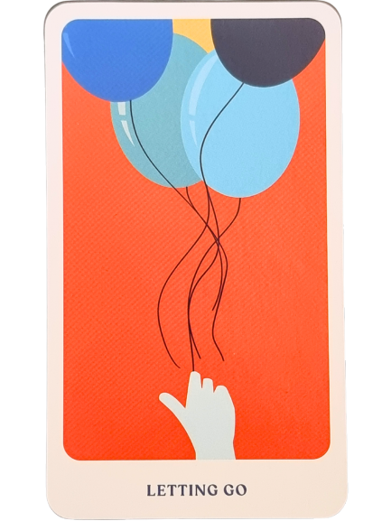 A hand releases three balloons—one yellow, one dark blue, and one light blue—into the air against an orange background, capturing a moment from The Story Oracle. The text at the bottom reads LETTING GO.