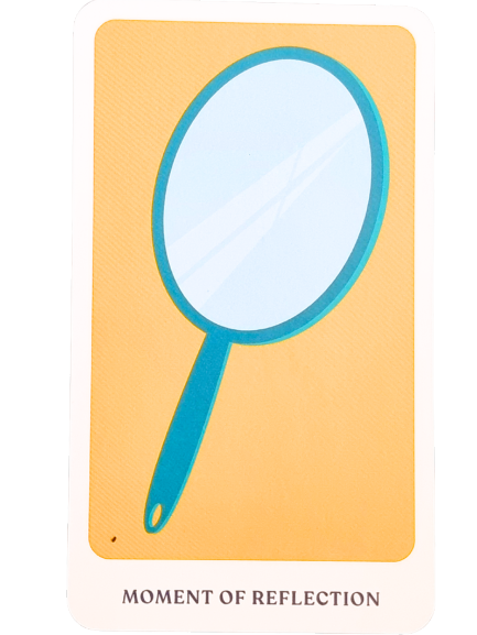 A card from The Story Oracle featuring an illustration of a blue handheld mirror on a yellow background. Below the image, the text reads MOMENT OF REFLECTION.