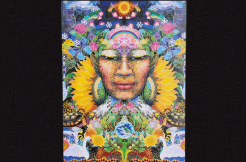 A colorful tarot card titled “Mother Nature” from The Sacred She Tarot shows a serene female face surrounded by sunflowers, animals, butterflies, and vibrant foliage, symbolizing harmony with nature. The card is part of a “Deck Review.”.