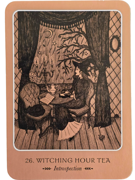 A spread of nine illustrated tarot cards arranged in a cross shape on a dark surface, with the Wild Woman Oracle tin box and booklet nearby. The cards feature detailed, sepia-toned artwork.