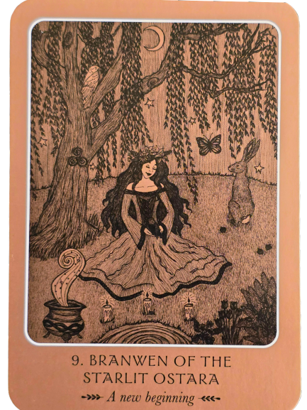 A woman in a flowing dress sits under a tree at night, surrounded by animals, lanterns, and flowers. A rabbit, owl, and butterfly are near. The card reads: “9. Branwen of the Starlit Ostara. A new beginning.” Wild Woman Oracle energy shines through.