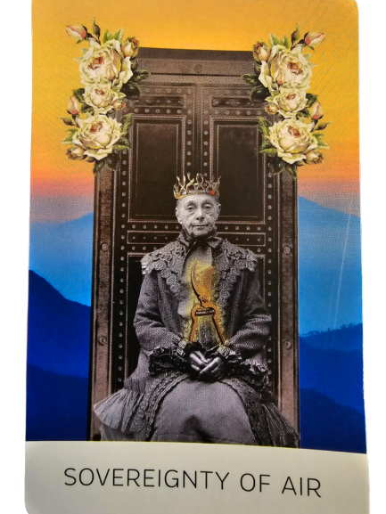 A grayscale elderly woman from The Rosebud Tarot sits on a throne, wearing a gold crown and holding a glowing staff. The throne is adorned with roses, with a blue and orange sunset sky and mountains behind her. Text reads “SOVEREIGNTY OF AIR.”.