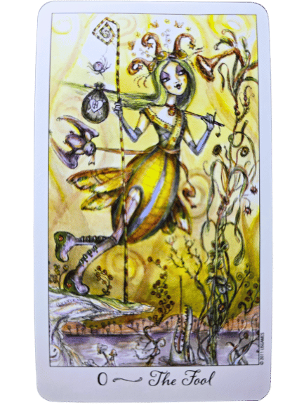 A whimsical Joie de Vivre Tarot card labeled 0 The Fool shows a jester-like figure in yellow and green with a knapsack on a staff, standing near a cliff with plants and a small animal, against a swirling yellow background.