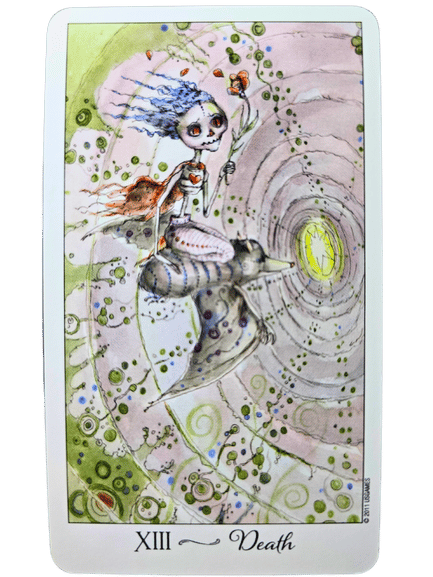 A whimsical Joie de Vivre Tarot card titled Death shows a doll-like figure with blue hair and a red dress riding a striped animal, holding a flower, surrounded by swirling green patterns and light at the end of a tunnel.