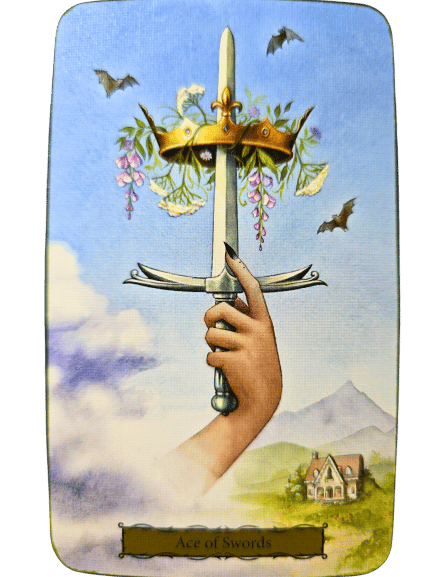 A hand emerges from clouds holding a sword upright, crowned with flowers and greenery. Bats fly above, with a house and mountains in the distance—a mystical scene from the Tarot of the Witch's Garden. Card label reads Ace of Swords.