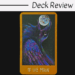 A tarot card titled 18 THE MOON from The Raven's Prophecy Tarot shows a colorful, mystical bird gazing up at a glowing full moon against a dark background. The border is gold, and above is a header that reads Deck Review.